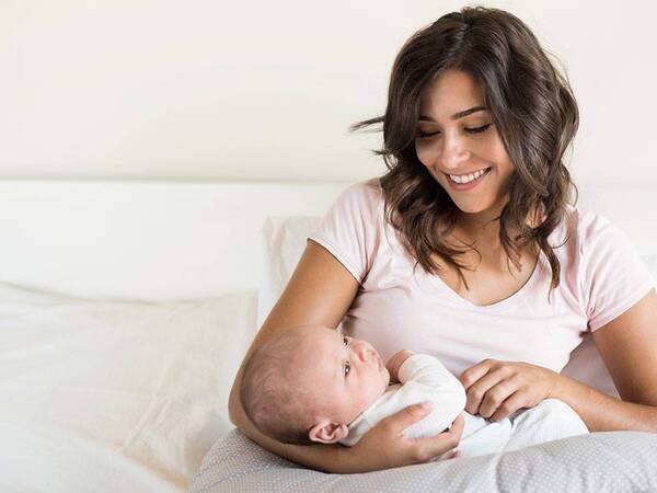 A mother holds her newborn baby at home. Scripps Health.
