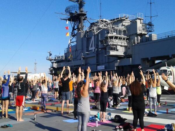 About 1,000 yoga enthusiasts participated in the 5th annual Yoga on the Midway, sponsored by Scripps Health and the Downtown San Diego Partnership.
