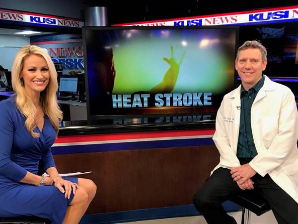 Mark Shaulata, MD., family medicine physician sits next to KUSI anchor Lauren Phinney after interview segment on the dangers of heat stroke.