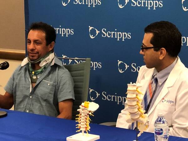 Hall of Fame jockey Victor Espinoza who was discharged from a Scripps hospital recently after surviving a bad fall, and Jihad Jaffer, MD, Scripps Encinitas rehabilitation specialist, speak during a news conference.