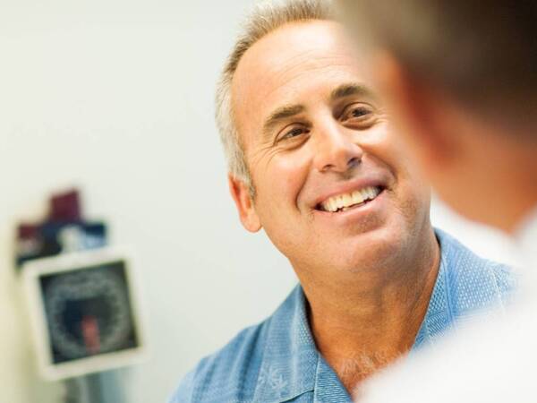 A male adult smiles as he talks to his provider at the new Scripps Health Express walk-in clinic in Rancho San Diego in East County.