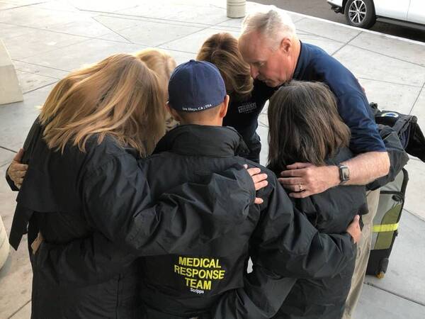 Scripps Health CEO and President Chris Van Gorder huddles with members of the second Scripps Medical Response Team before they head to Northern California to help with Camp Fire victims.