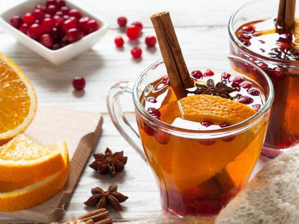 A healthy holiday tea is pictured with cinnamon, nutmeg, oranges and pomegranates. 