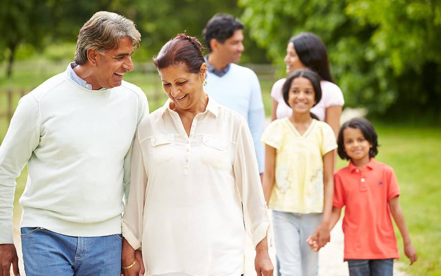 A happy couple holding hands and walking, represents healthy lifestyle that may come with attending the matter of balance program at Scripps Health in San Diego.