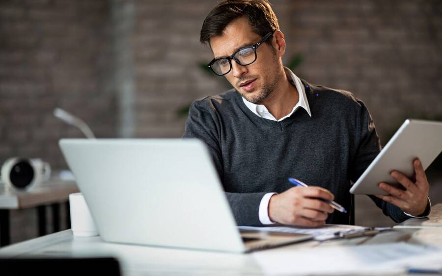 Adult using up screen time on electronic devices at work.