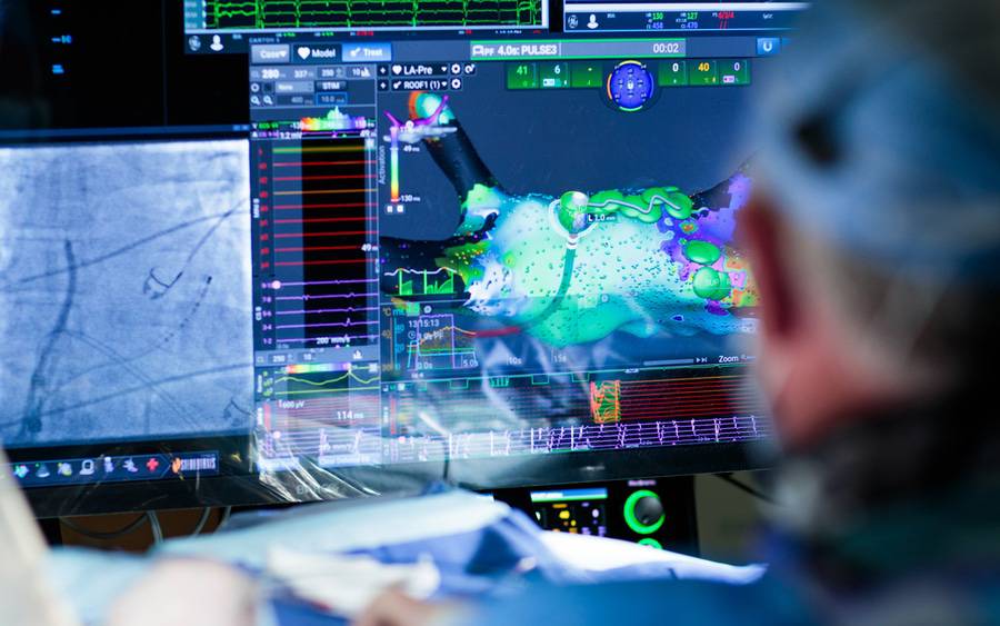 A cardiac electrophysiologist looks at advanced images of the heart in atrial fibrillation treatment.
