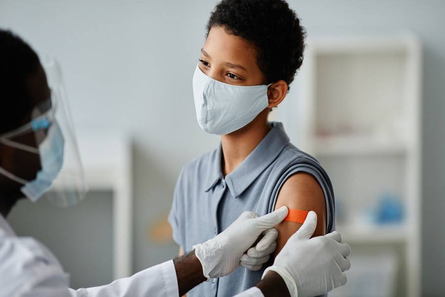 An African-American youth receives the HPV vaccine.