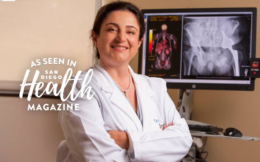 Dr. Anna Kulidjian, Orthopedic Surgeon, Scripps Clinic standing in front of a computer with a hip x-ray on the screen.