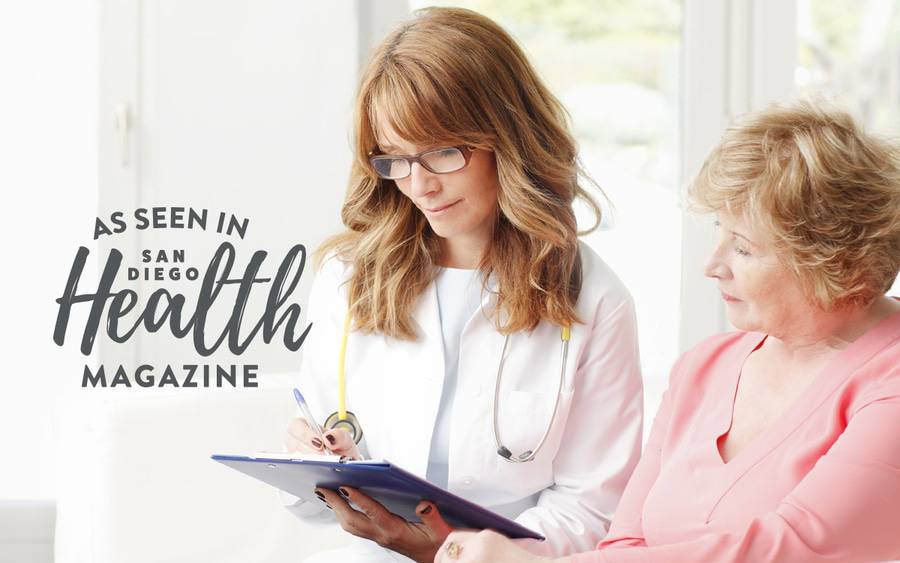 MD reviewing documents with patient, representing a patient at their annual physical.