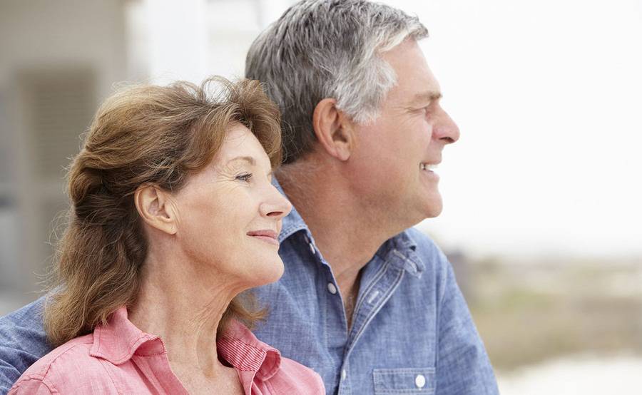 A smiling couple on the beach represents a healthier life with treatment for aortic aneurysm or aortic dissection.