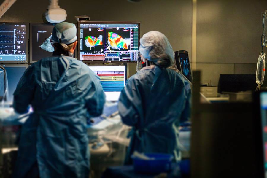 Two Scripps electrophysiologists study an image during an arrhythmia procedure.