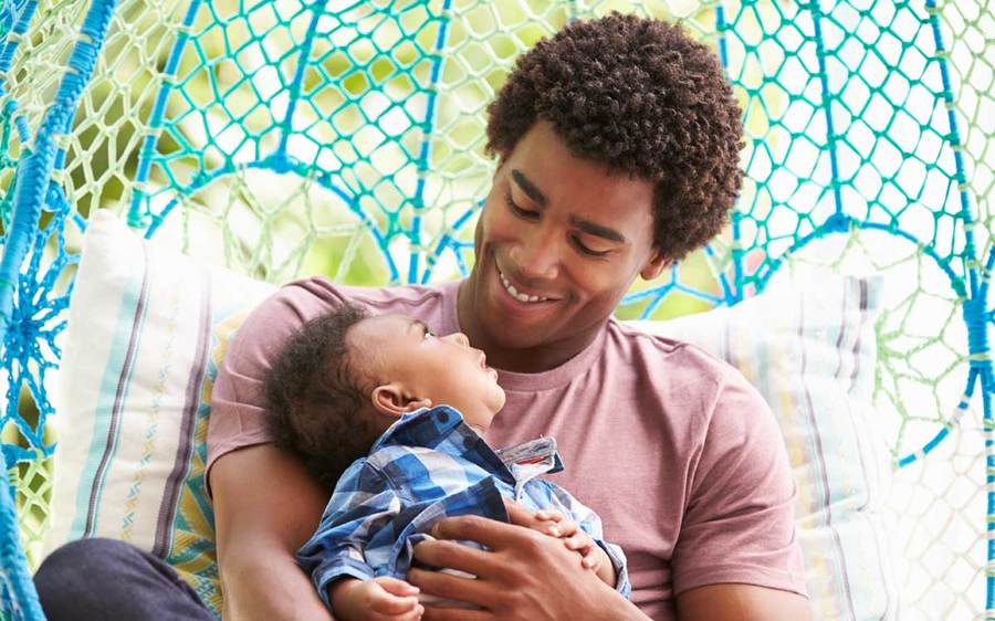 Father and baby son gaze at each other.