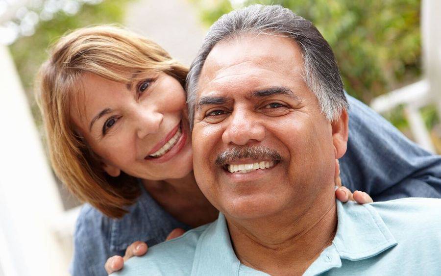 Husband and wife in theirs 50s or 60s smile.