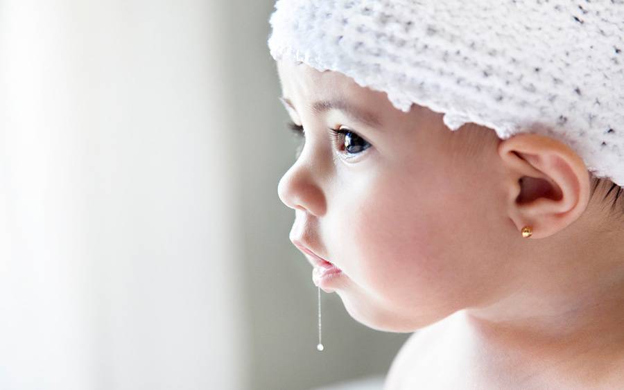 A baby drooling raises concerns about developing a rash to her parents.