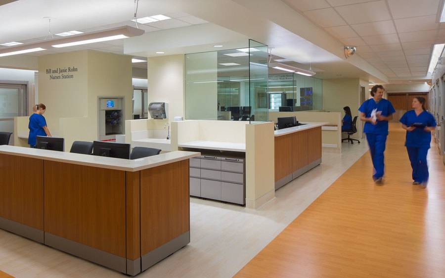 A nurses station and nurses walking in the Barbey Family Emergency and Trauma Center