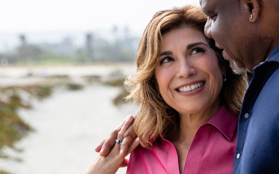 Elizabeth Mireles Riggs, smiling with her husband Michael in nature. The photo shows her after bariatric surgery that helped her lose more than 100 pounds.