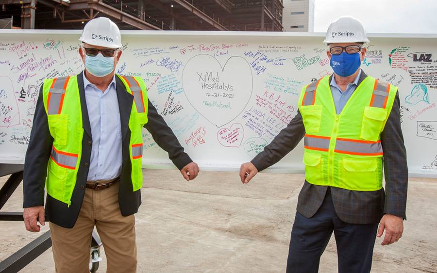 Philanthropists sign a beam at the La Jolla Memorial Hospital.