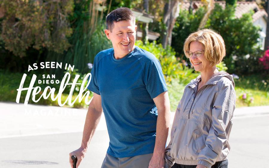 Bone cancer survivor Erich Boldt walks with his wife, grateful to be on his feet after Scripps doctors implanted a device that preserved his ability to walk.