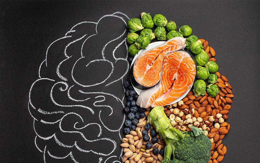 A diagram of a brain that includes pictures of fish, nuts, berries and vegetables.