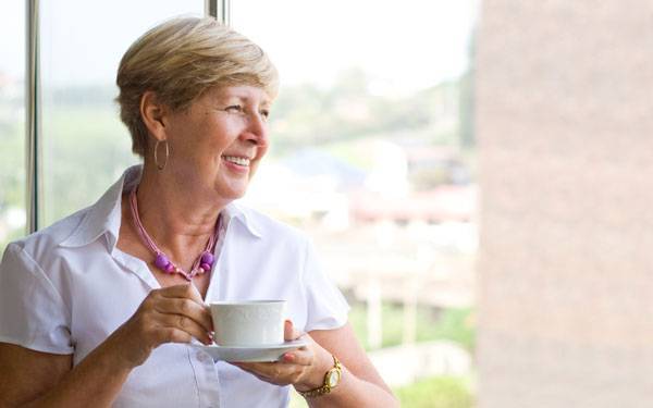 A smiling mature woman represents the full life that can be led after breast cancer treatment.