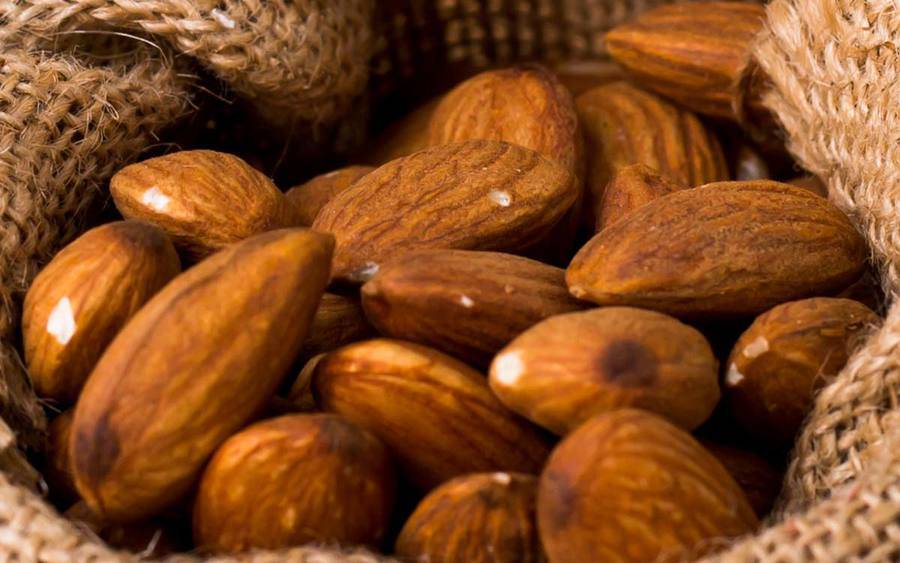 A group of almonds represents how adding nuts to your diet may help prevent cancer.