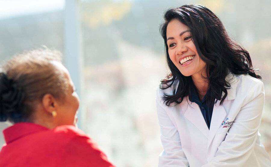 A Scripps MD Anderson Cancer Center oncology nurse navigator shares a warm moment with a cancer patient.