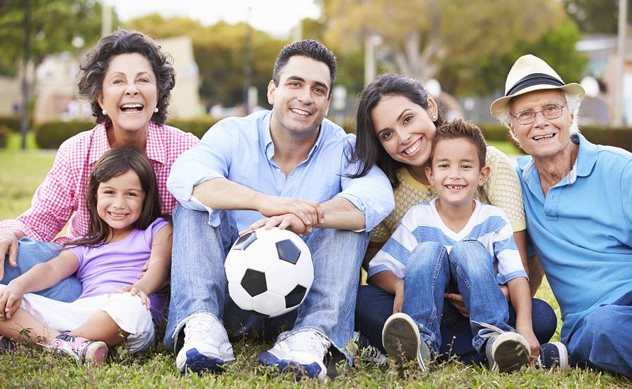 Hispanic family sitting at park