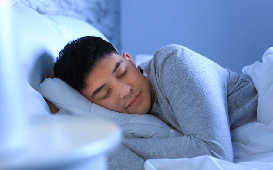 A young Asian man sleeps soundly after getting help to reset his circadian sleep rhythm.