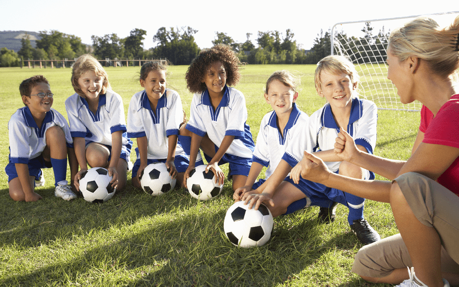 Three boys playing soccer