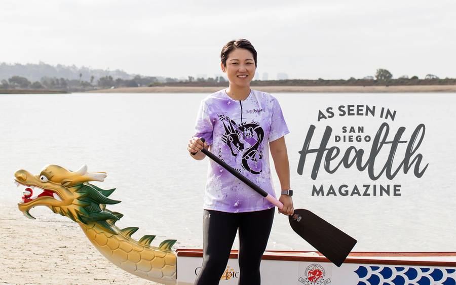 Dr. Ni-Cheng Liang next to a dragon boat.