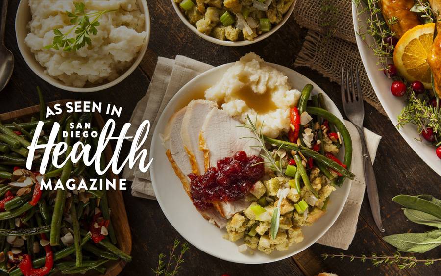 A plate full of turkey, stuffing, mash potatoes and green beans.