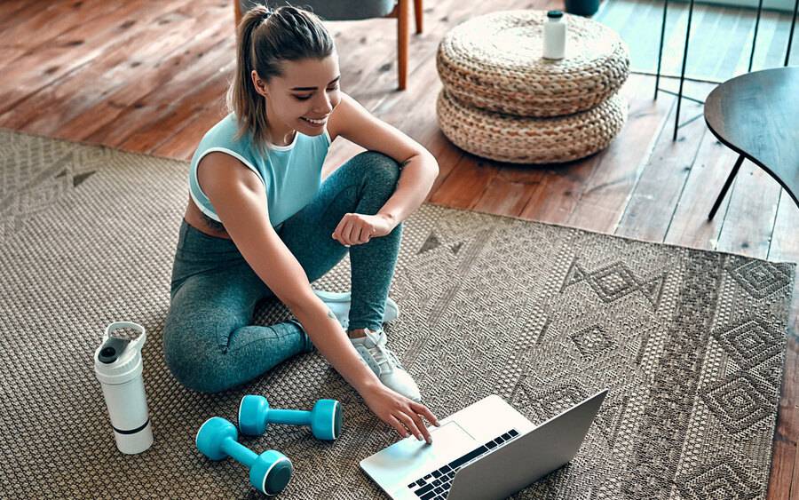 Young woman participates in online exercise class. Staying home due to coronavirus.outbreak.