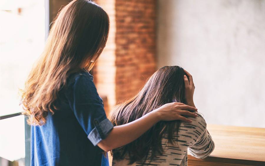 A mental health care provider helps a young woman struggling with depression.