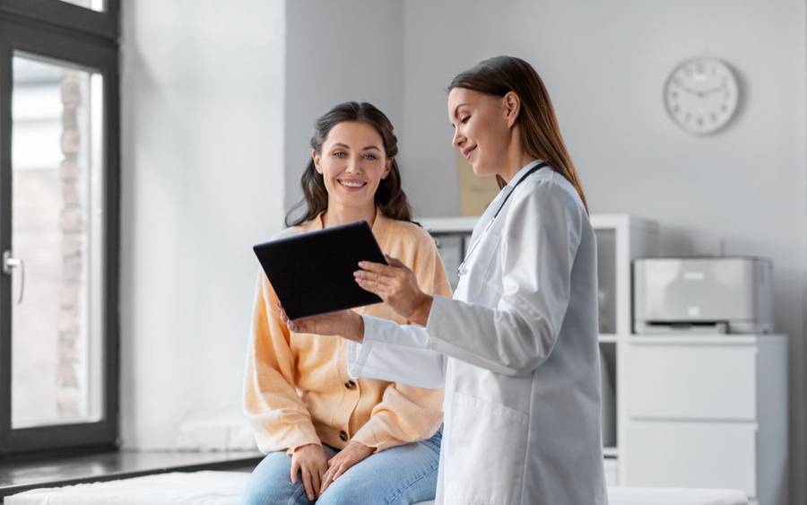 A patient and her primary care physician going over care plan.