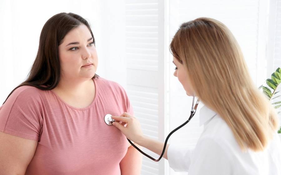 A bariatric surgery candidate gets checked by her physician.