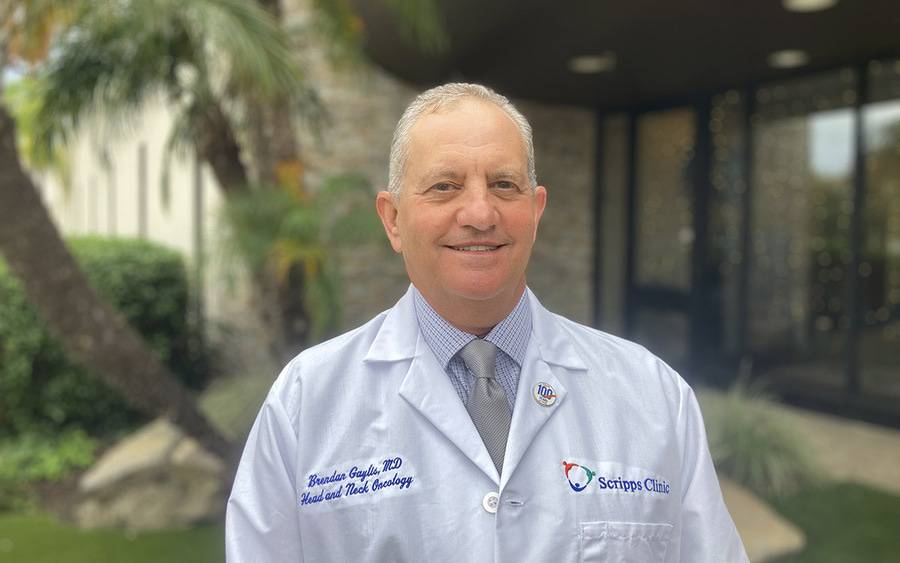 Dr. Brendan Gaylis, Oncologist for Scripps Cancer Center and Scripps Clinic, is standing outside smiling.