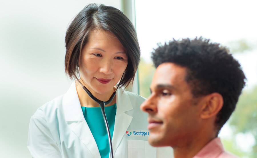 Dr. Siu Ming Geary, Internal Medicine, Scripps Clinic physician examines a patient in a clinical office. 
