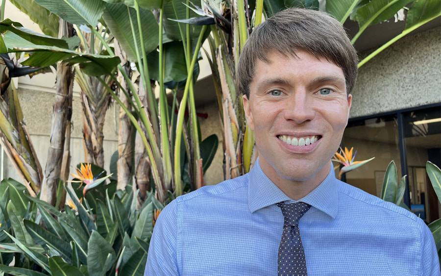 Dr. Mitch Biermann, an internal medicine physician for Scripps Clinic, is standing outside smiling.