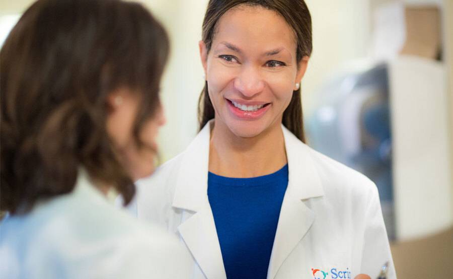 Dr. Rio Dickens- Celestin, Internal Meidicne, Scripps Clinic, smiling while talking to a patient.