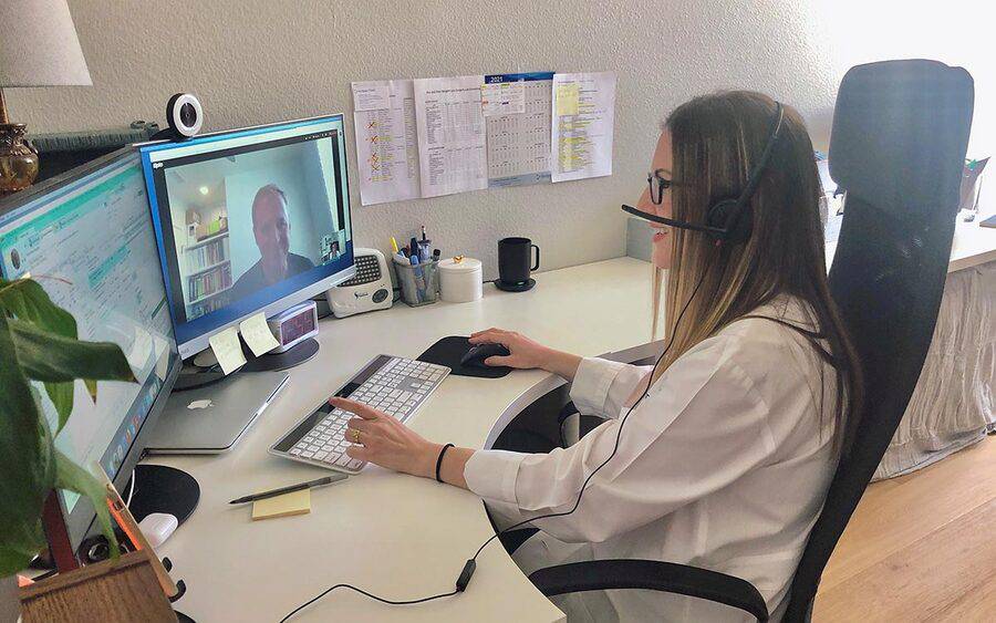 On her home computer, Dr. Samantha Harris conducts a telehealth visit with a patient.