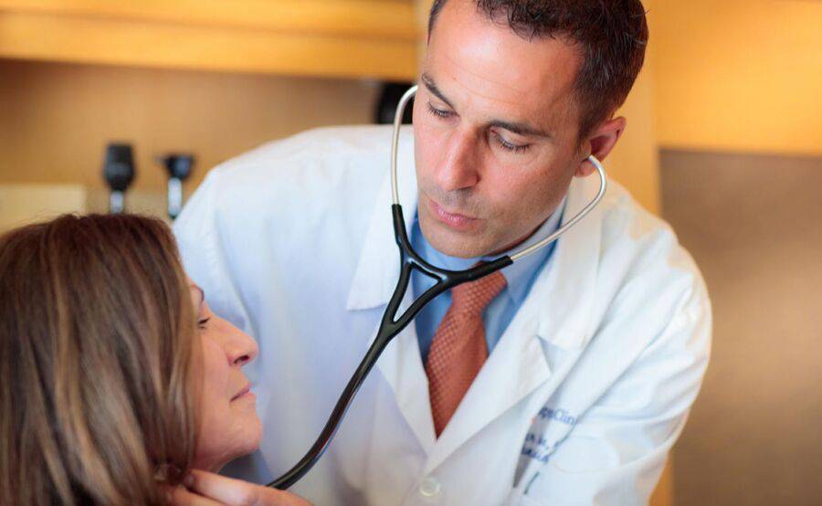 Integrative medicine physician, Dr. Suhar examining a patient.