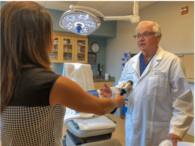 Dr. Hugh Greenway, a dermatologic surgeon at Scripps Clinic, discusses the findings of a new study on sunscreeen with TV reporter.