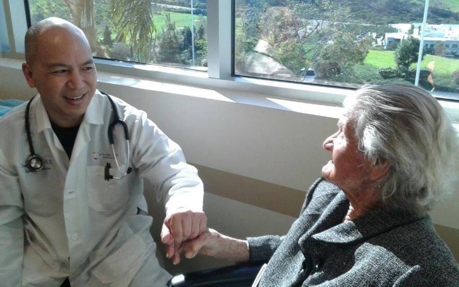 A Scripps doctor comforts and elderly patient in need showing why Scripps Medical Group is recognized for excellence.