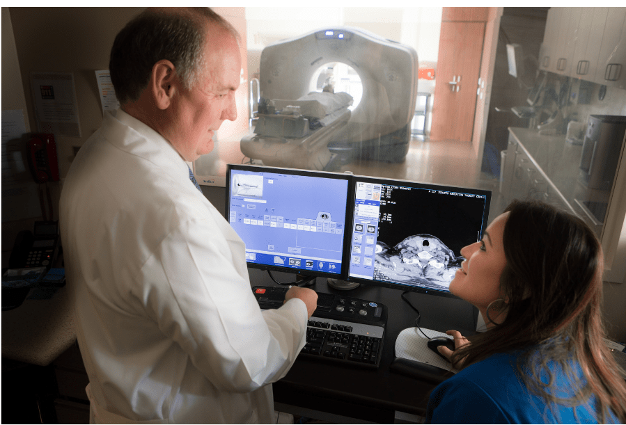 Dr. Thomas Buchholz, medical director of Scripps MD Anderson Cancer Center, discusses patient treatment plan with an oncology nurse.