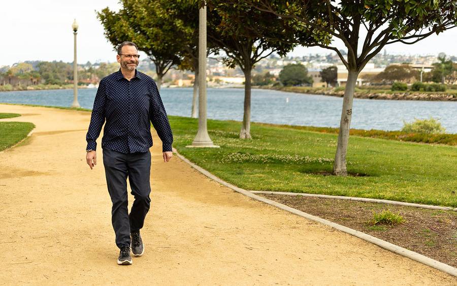 Dustin Smith walking on a path outside illustrating a Scripps Health Bariatric Surgery patient story success.