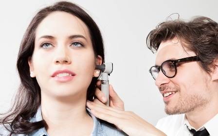 A doctor assesses ear problems in a female patient, which were discussed by a Scripps Expert on KUSI news.