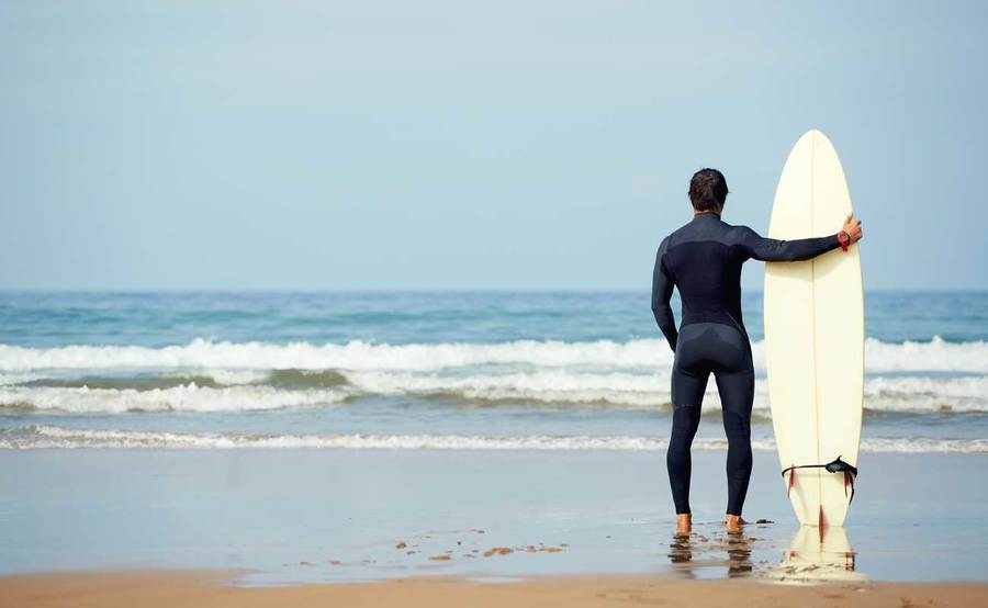 Encinitas surfer returns to the water with his surfboard after successful surgery and rehabilitation with Scripps Health.