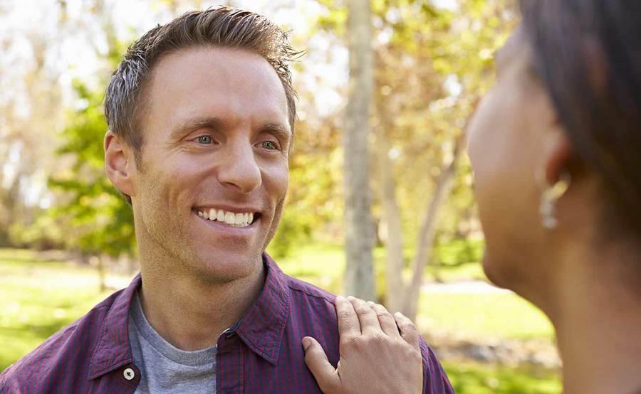 A smiling young Caucasian man and African-American woman represent the full life that can be led after endocrine cancer treatment.