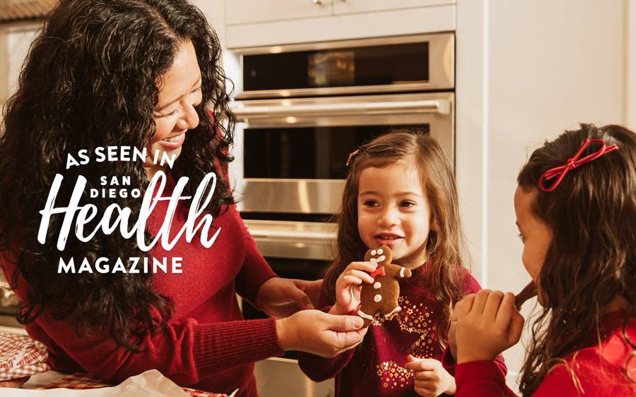 A mother and her two daughters baking a healthy version of gingerbread cookies for the holidays.