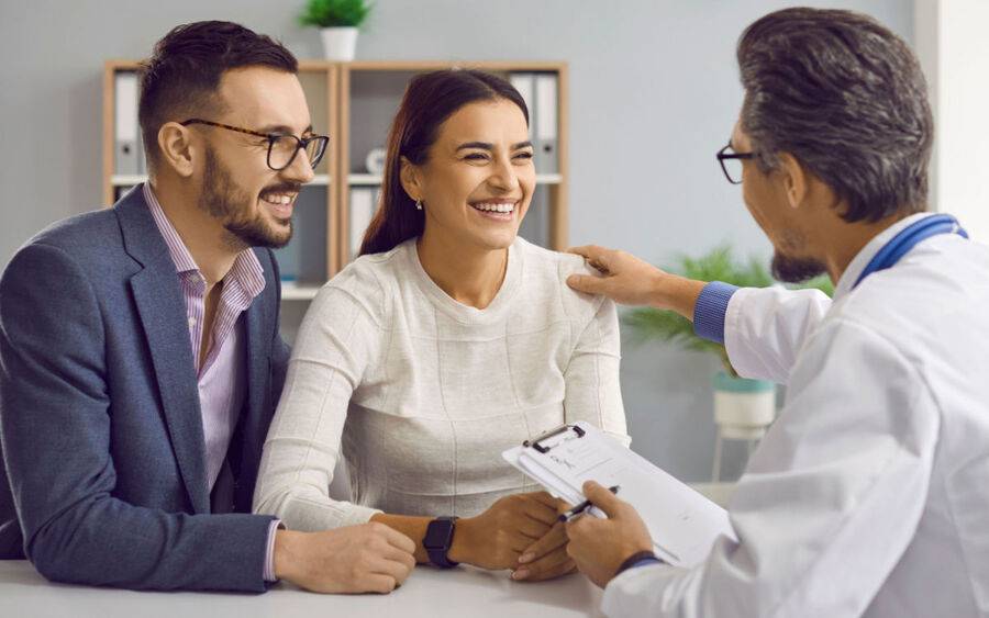 A couple discusses infertility treatment with physician.